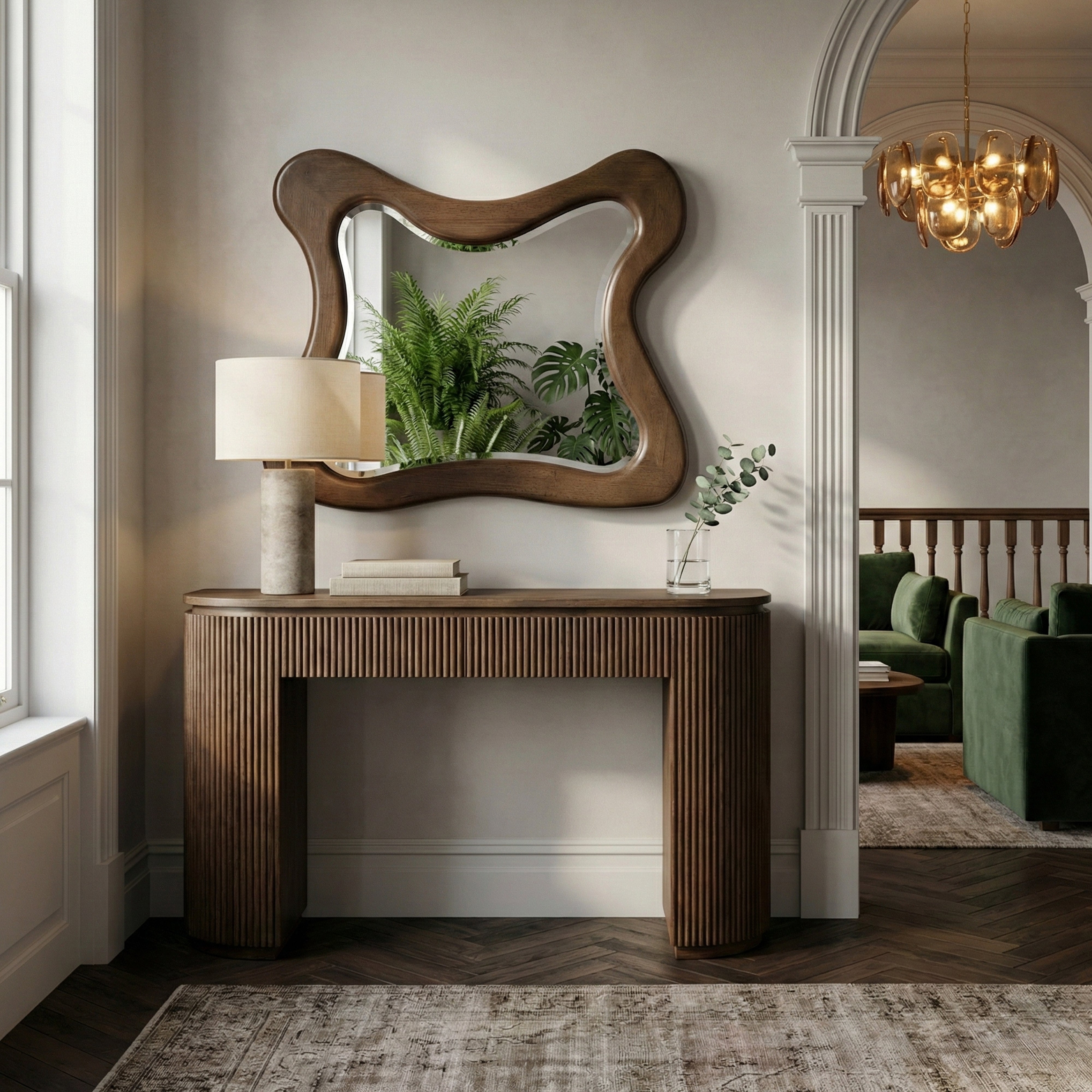 Oro Wall Mirror with a natural wood wavy frame above a fluted rich brown walnut console table.