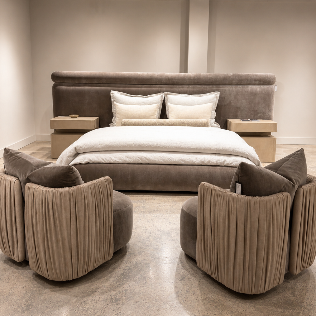 Luxury bed with designer swivel chairs in a neutral color scheme