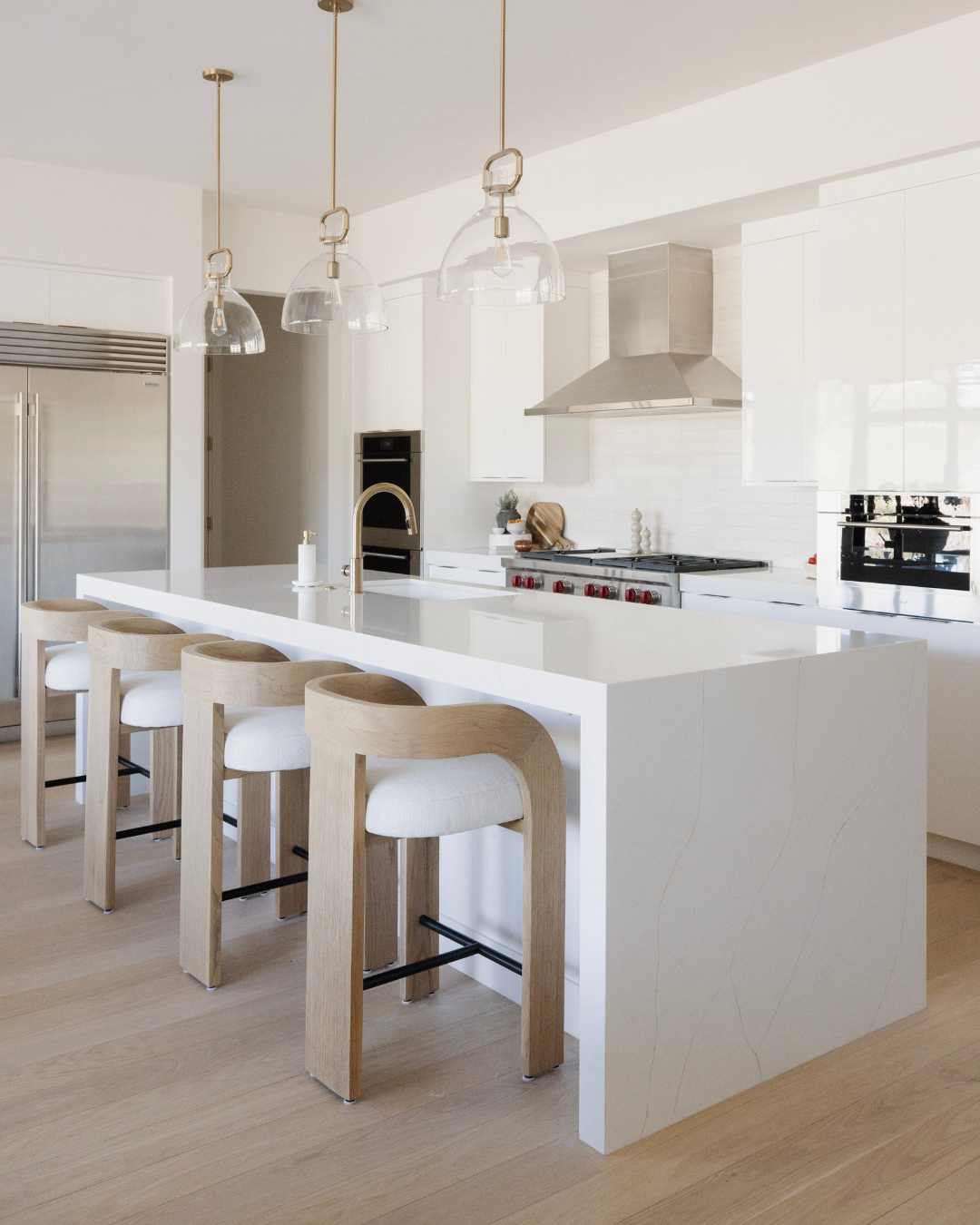 Modern kitchen with white island and bar stools
