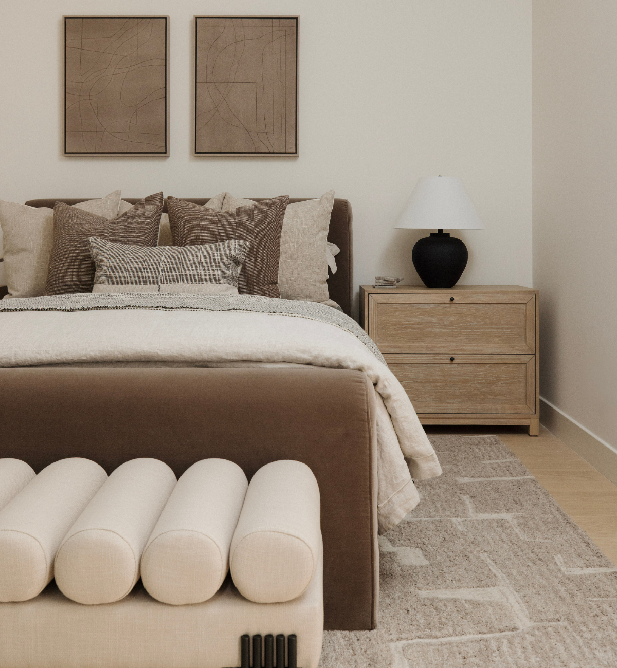 Modern bedroom with a bed, nightstand, and wall art