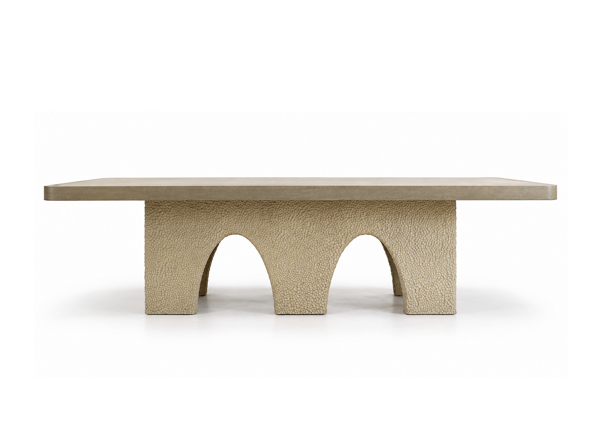 A modern rectangular coffee table with a textured concrete base featuring three arches and a smooth top, shown against a plain white background.