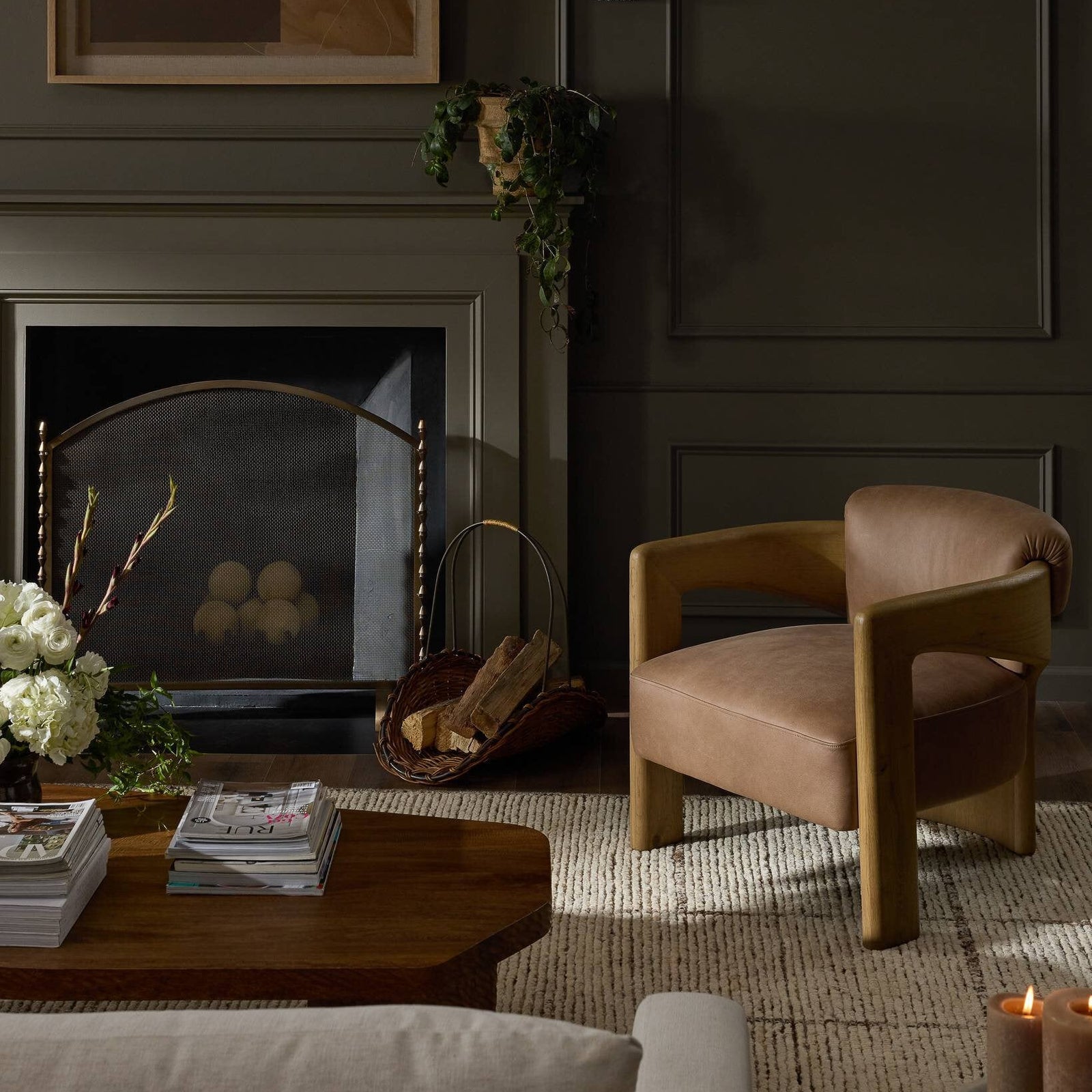 Layered living room with anchoring furniture, a rug, and sculptural seating