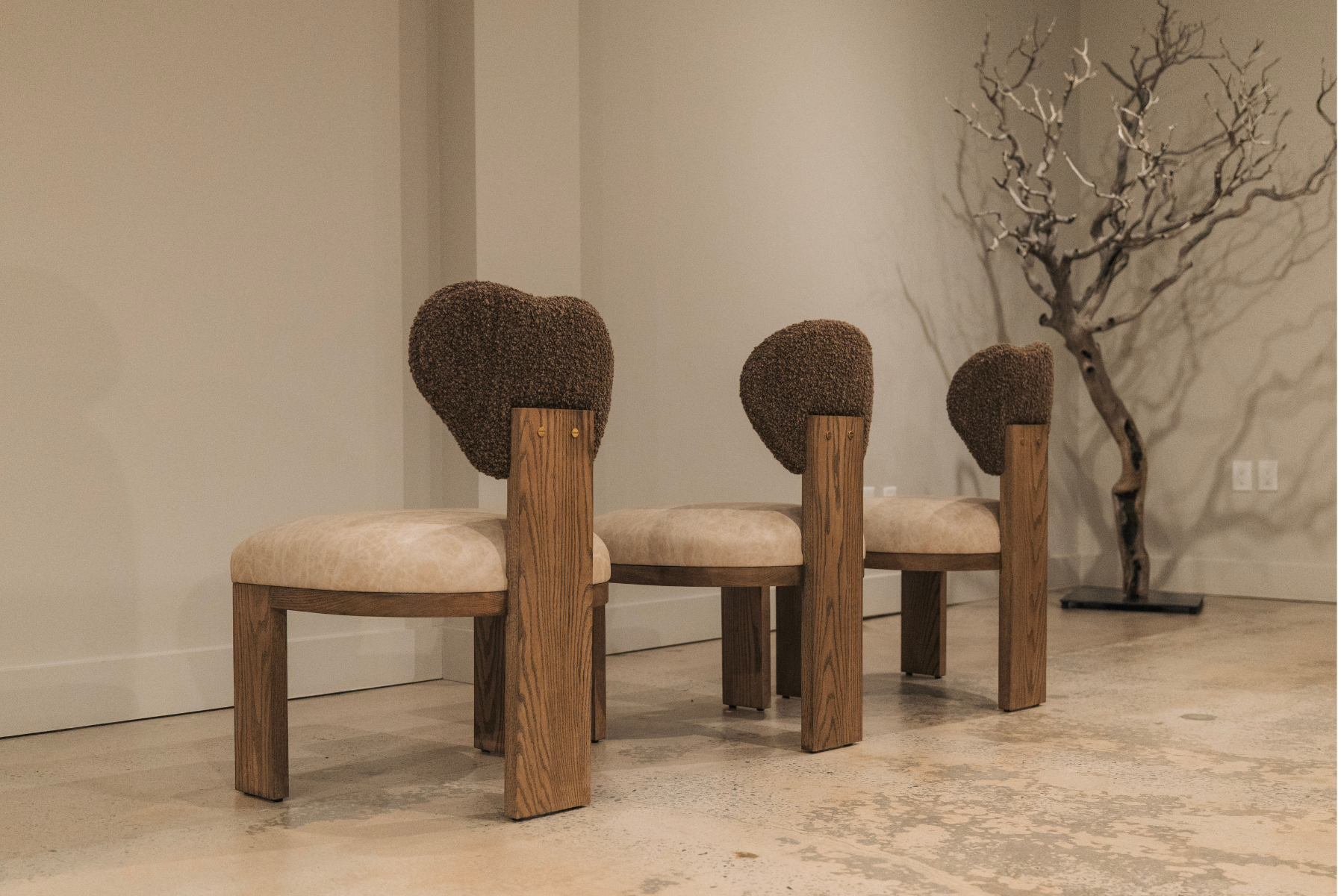 Sculptural oak dining chairs with boucle backs, shaped by desert forms, from Kristen Hancock x Rene Cazares, by StyleMeGHD.
