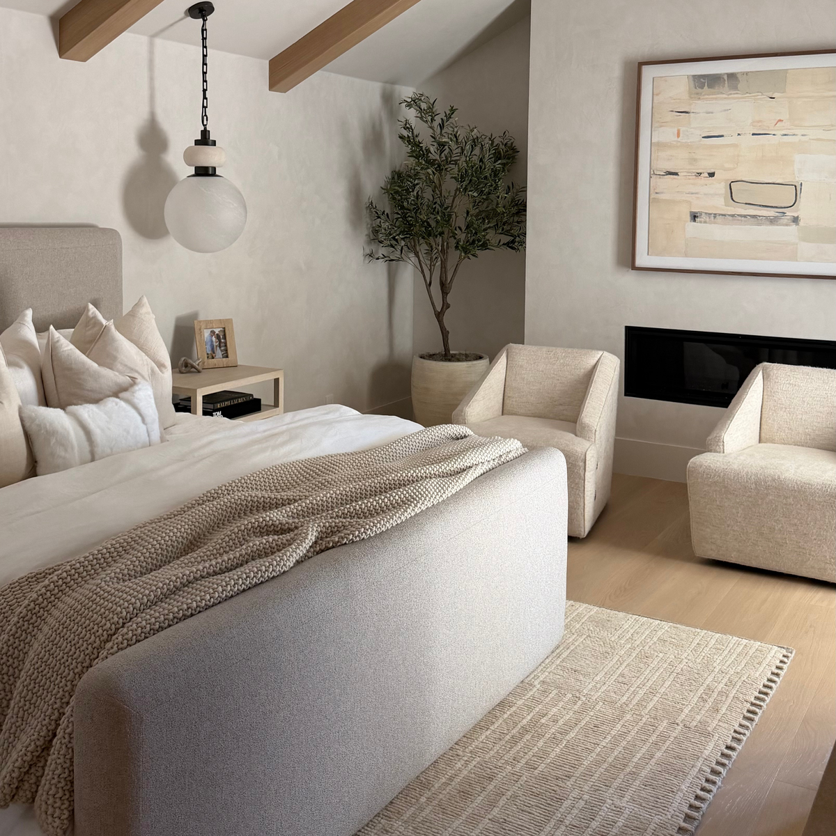 layered landscape artwork in beautiful master bedroom