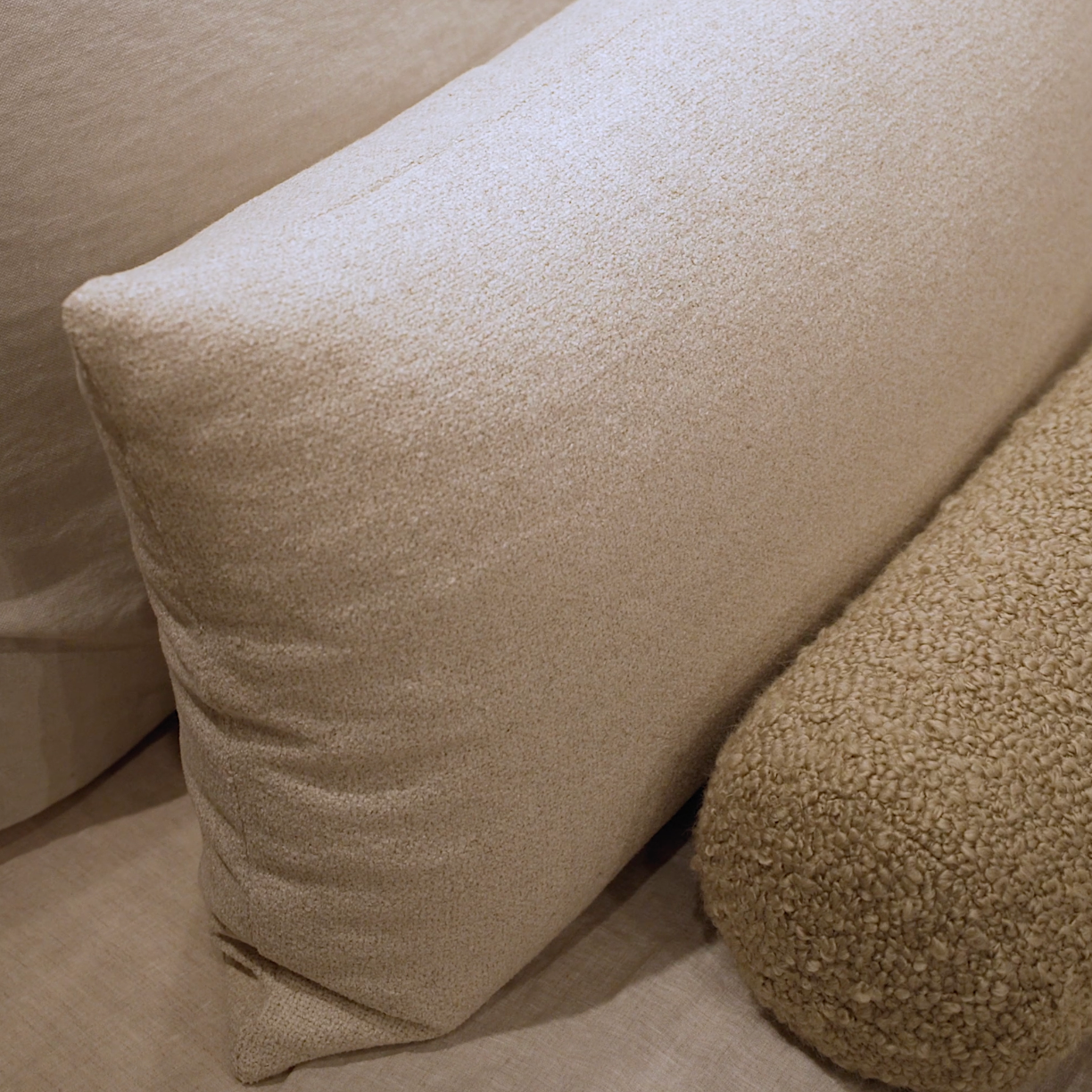 Beige pillows on a sofa with a textured surface
